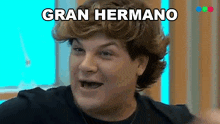 a man is making a funny face with the word gran hermano written above him