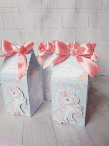 three boxes with a unicorn and the name manuela