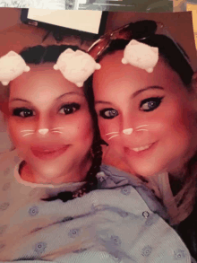 two women wearing hello kitty face masks are posing for a photo