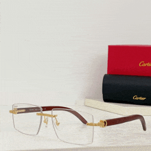 a pair of cartier glasses sit on a shelf next to a cartier box