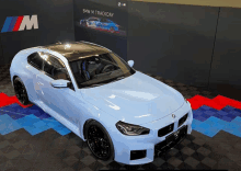 a bmw m trackday car is displayed in a room