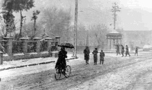 a group of people are walking down a snowy street