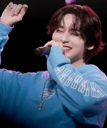 a young man wearing a blue sweatshirt that says ' a.m.a.r.d.s. ' on it