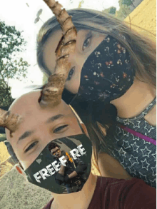 a man and a woman wearing face masks that say free fire on them