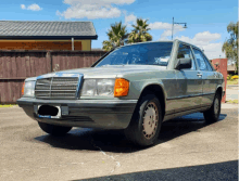 a green mercedes with a license plate that says mercedes benz