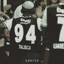 a soccer player with the number 94 on their jersey