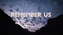 remember us is written on a cloudy sky over a canyon