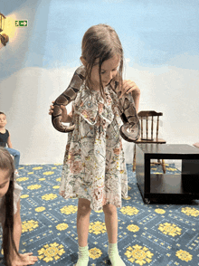 a little girl is holding a snake in her hands