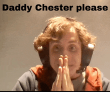 a man wearing headphones with the words " daddy chester please " below him