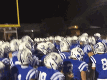 a group of football players wearing blue and white uniforms with the number 8 on the back of their jersey