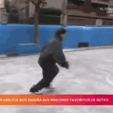 a man is ice skating on a rink in front of a sign that says ' el congo ' on it .