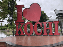 a large red sign that says i love kochi with a heart