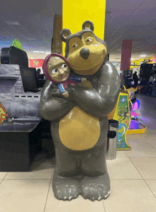 a statue of a bear holding a baby in a room