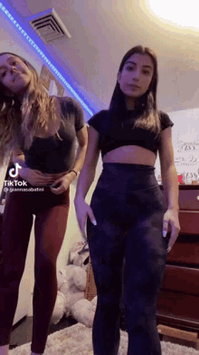 two girls are standing next to each other in a room with a tiktok written on the bottom of the video