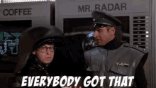 two men are standing next to each other in front of a machine that says mr radar