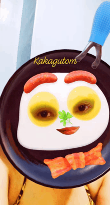 a person is holding a plate with a face on it and the words kakagutom on it