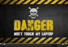 a laptop with a danger sign on it .