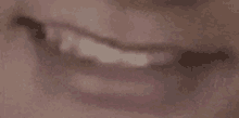 a close up of a person 's mouth with their teeth visible .