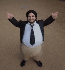 a man in a suit and tie with his arms outstretched looks like a turkey