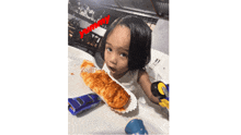 a little girl eating a croissant with the word yummy written on the bottom