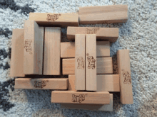 a bunch of wooden jenga blocks on a rug