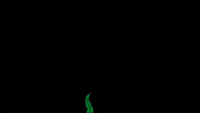 a green flame is coming out of the bottom of a black background .