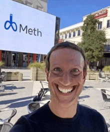 a man is taking a selfie in front of a meth sign