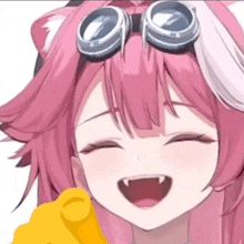 a pink anime girl with goggles on her head is smiling