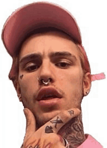 a man wearing a pink hat and a pink shirt has a nose ring .