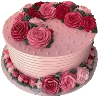 a pink cake with pink roses and pearls on top