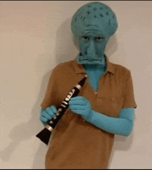 a man dressed as squidward from spongebob squarepants is playing a clarinet .