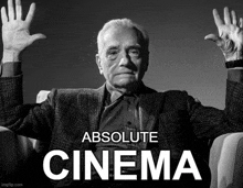 a black and white photo of a man with his hands in the air and the words absolute cinema below him