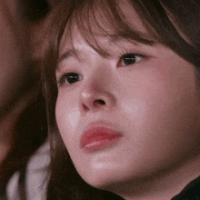 a close up of a woman 's face with tears running down her face