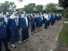 a group of students standing in a line with one wearing a hat that says sd