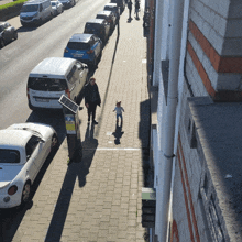 a row of cars are parked on the side of a street with a sign that says p.