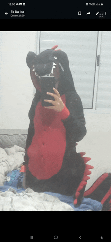 a person is taking a picture of themselves in a dragon costume