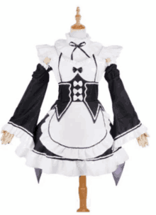 a black and white maid costume with ruffles and a bow