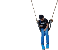 a boy is sitting on a swing wearing a shirt that says ' i love you ' on the front