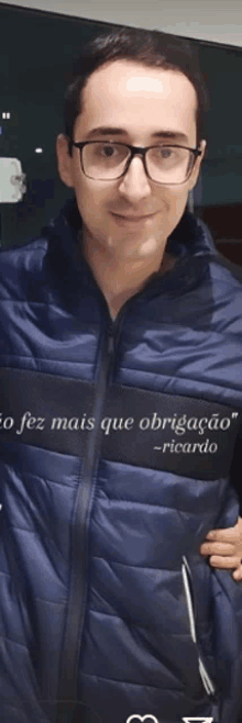 a man wearing glasses and a jacket that says " ricardo "