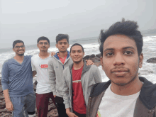 a group of young men are posing for a picture with one wearing a t-shirt that says ' saturday ' on it