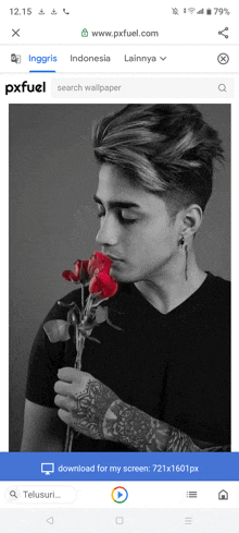 a black and white photo of a young man holding a red rose