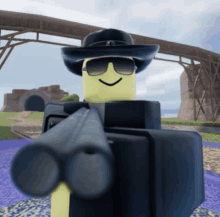 a yellow robot wearing sunglasses and a cowboy hat is pointing a gun