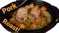 a pot of pork roast with carrots and celery in it