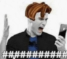 a man with a lego head is holding a cell phone and yelling .