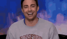 a man wearing a sweatshirt that says bossford on it