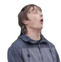 a man in a gray jacket is making a funny face with his mouth open