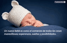 a baby wearing a knitted hat with ears is sleeping on a blue blanket .