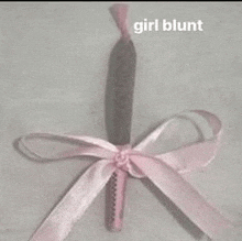 a girl blunt with a pink ribbon around it .