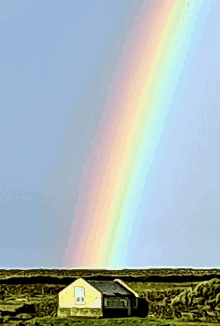 a rainbow is visible over a house with a window that says ' a ' on it