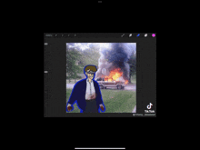 a picture of a man standing in front of a burning car has a tiktok watermark on it